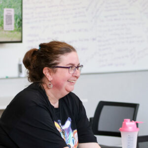 image of woman seated in front of a whiteboard